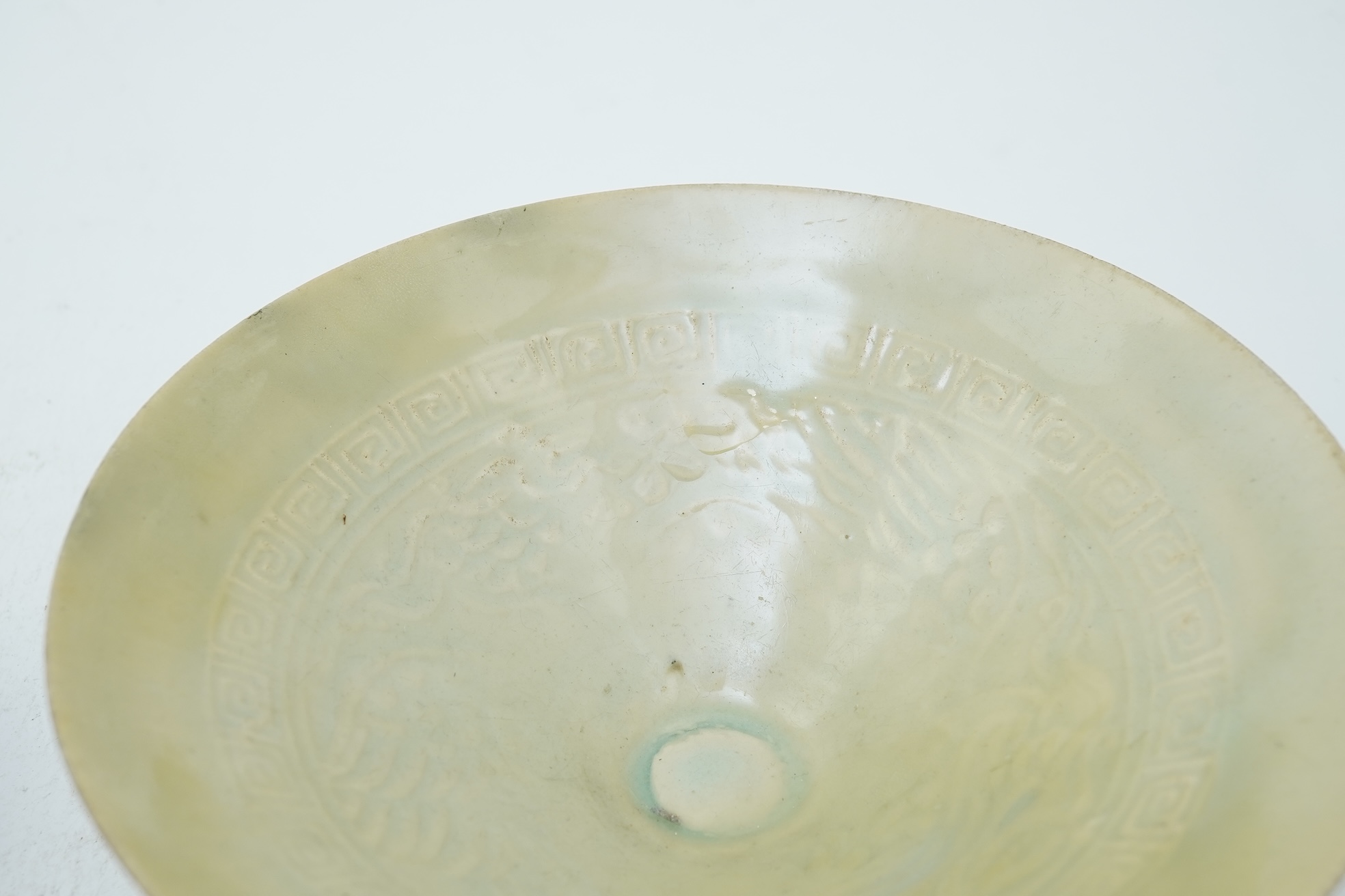 A Chinese Ding type circular dish, Song dynasty and a qingbai moulded conical bowl, Song-Yuan dynasty